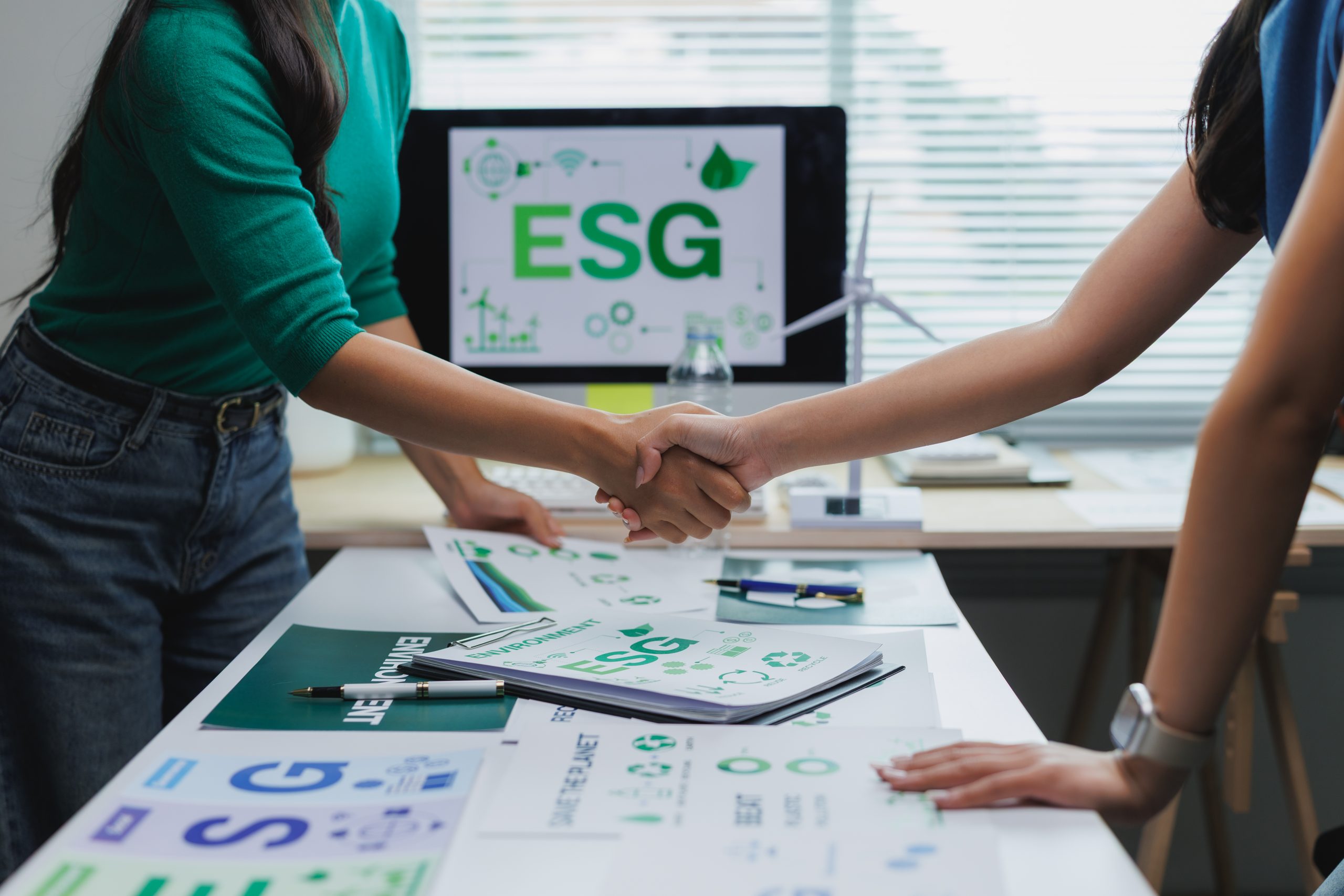 businesswomen shaking hands on environmental, social, and governance esg project
